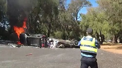 A couple have been pulled from the wreckage of their car just seconds before the vehicle exploded.Two Western Australia Police officers rushed towards the crashed car and caravan after the driver lost control at a bend along the South Western Highway near Harvey, in the state's south-west, last month.