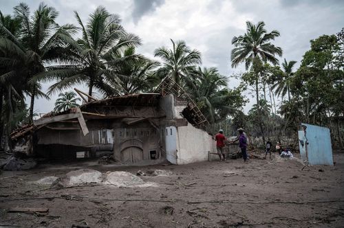 Villagers salvage what they can after the Mount Semeru volcano erupted in Indonesia