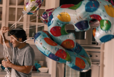 Paul Rudd in the movie This is 40 carrying balloons for wife's birthday.