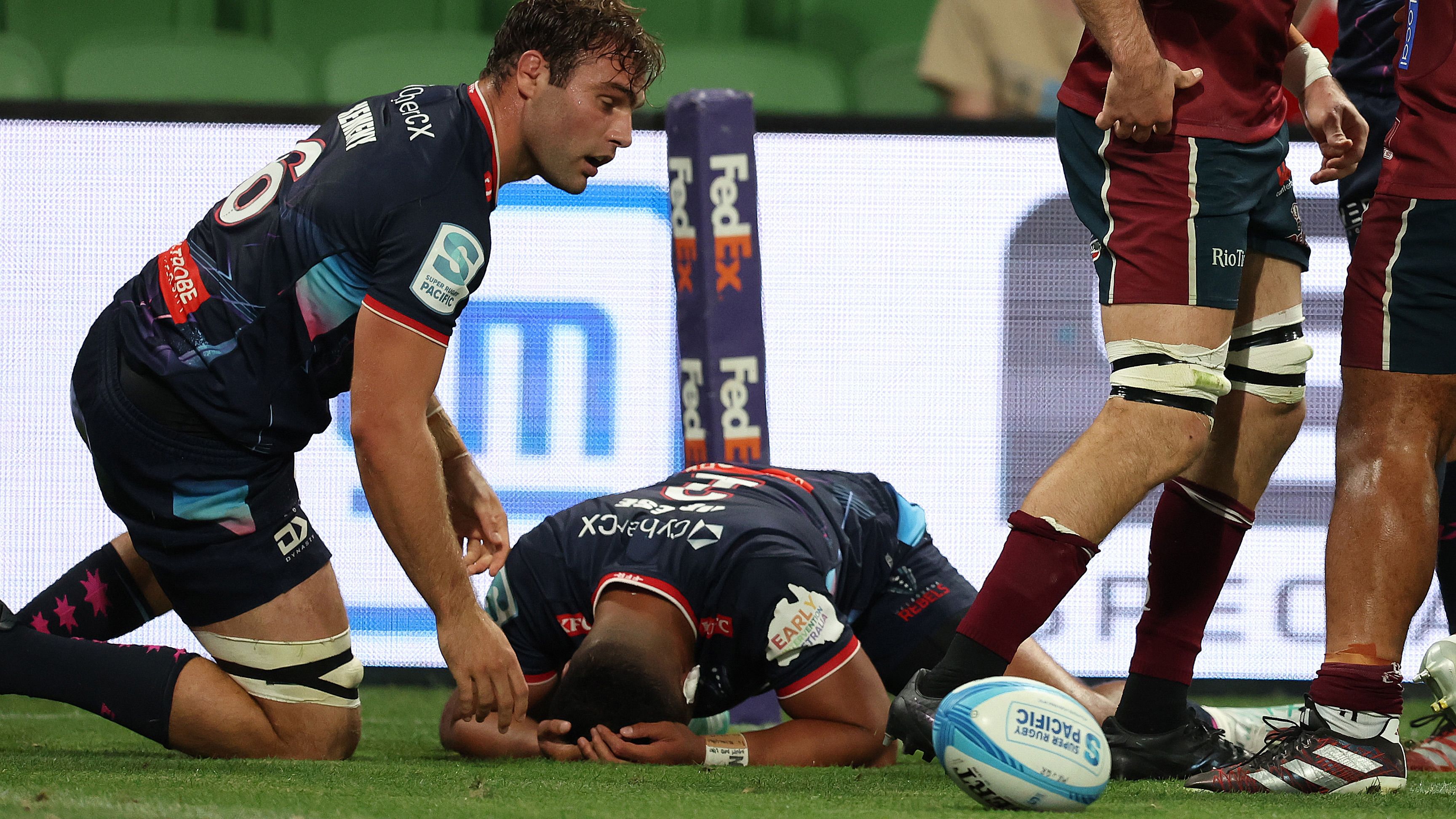 Melbourne Rebels players react to another Queensland Reds try.