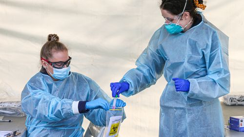 Paramedics place a swab test into a medical bag to send of testing at a Covid-19 pop up testing centre in the hotspot suburb of Brunswick West on July 04, 2020 in Melbourne, Australia. 