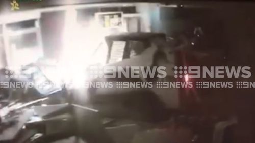 The CCTV shows the Bobcat plough into the service station.