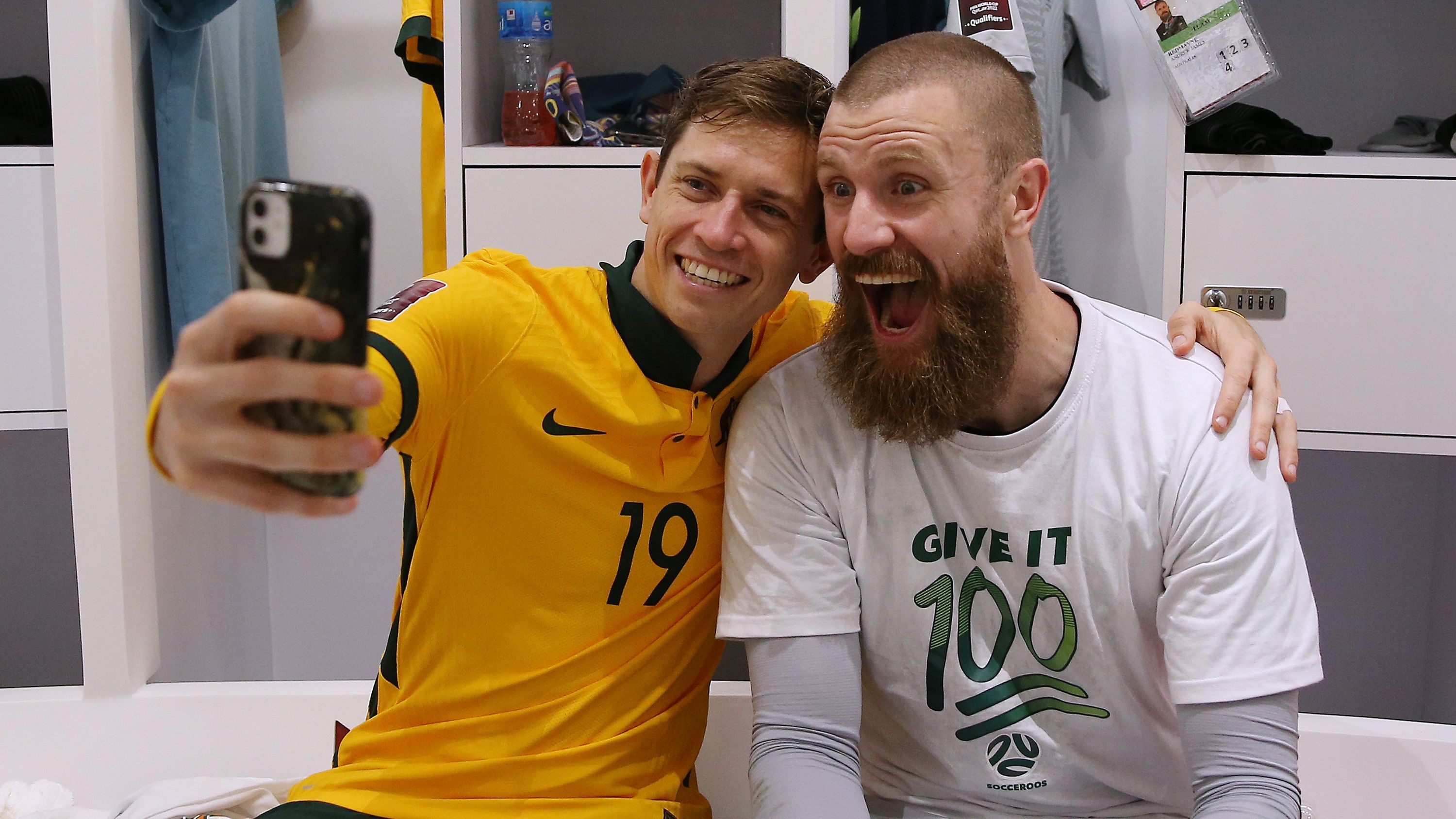 Craig Goodwin and Andrew Redmayne of Australia celebrate their victory after a penalty shoot out against Peru at Ahmad Bin Ali Stadium.