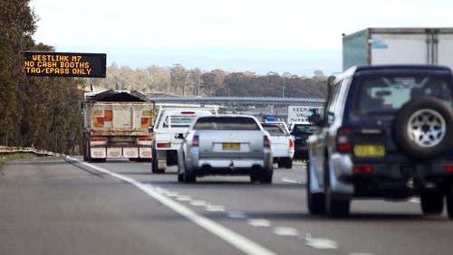 Vehicles travel along the Westlink M7 motorway in Sydney, Australia