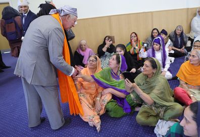 King Charles III speaks to congregation members during a visit to the newly built Guru Nanak Gurdwara on December 06, 2022 in Luton, England.  