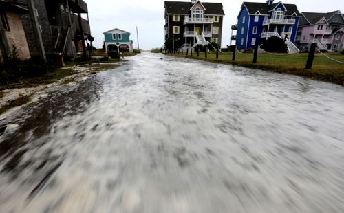 Ocean water rushes down a street on Hatteras Island as the effects of Hurricane Florence reach the coast of the Carolinas.