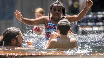 People gathered at Keller Fountain Park to take a dip and cool off, in Portland, Oregon.