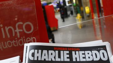 A special edition of the satirical newspaper Charlie Hebdo that marks one year after, &quot;1 an apres&quot; the attacks on it, on a newsstand Wednesday, Jan. 6, 2016 at a train station in Paris. 
