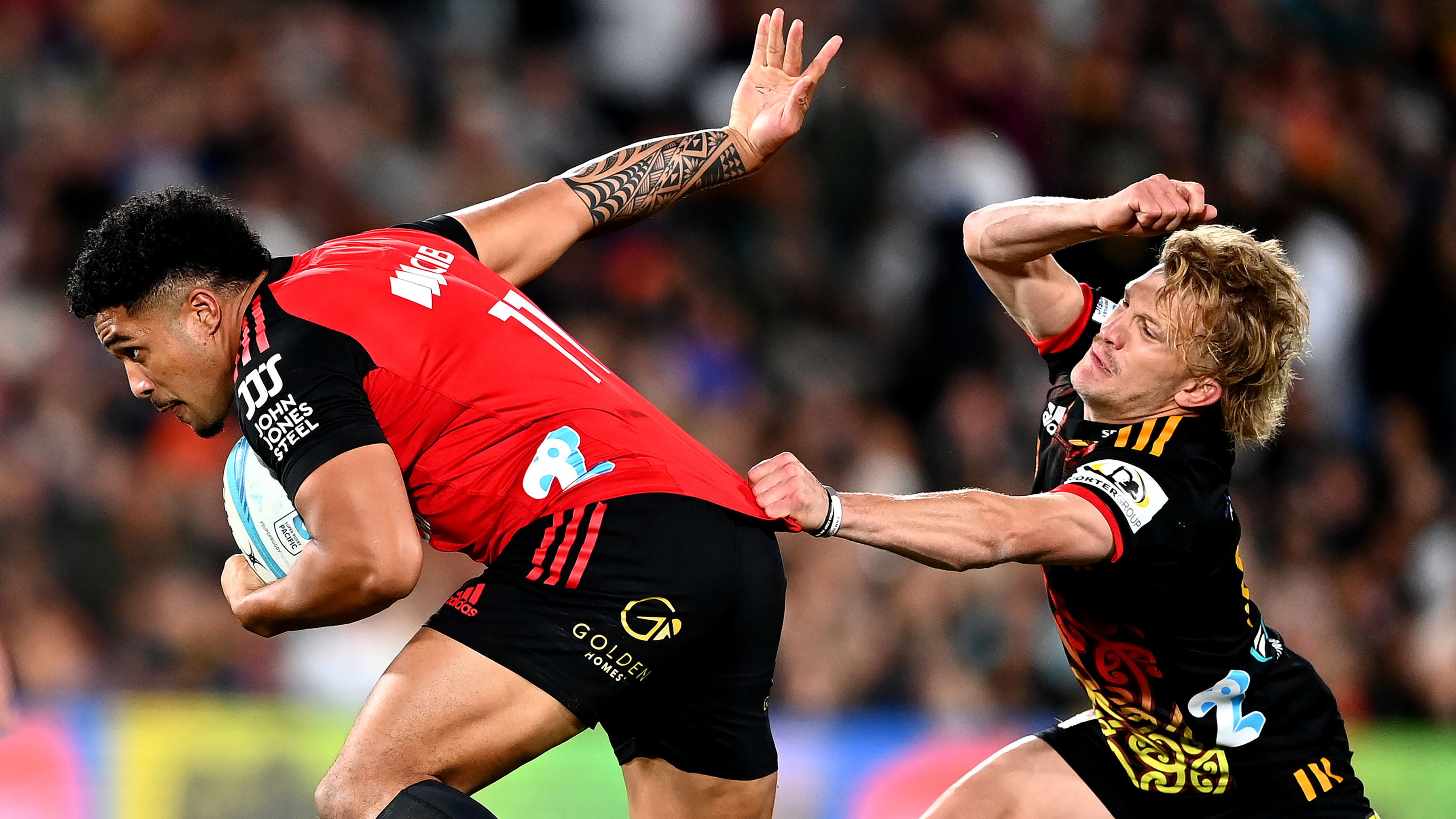 Leicester Fainga&#x27;anuku of the Crusaders evades Damian McKenzie of the Chiefs.