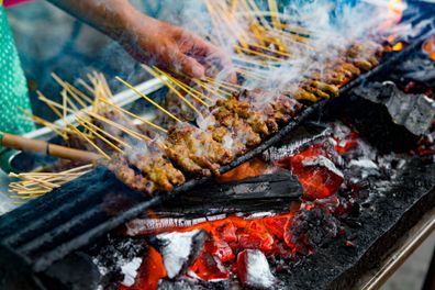 Satay is a marinated skewered chicken and meat which is a popular street food dish in Malaysia.  It is usually grilled on a makeshift or mobile stall by the roadside. There are also other versions of satay around the Southeast Asia region with various type of meat.