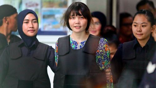 Vietnamese Doan Thi Huong, center, is escorted by police. (AP)