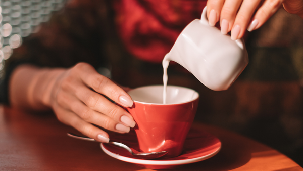 Pouring milk into a cup of tea