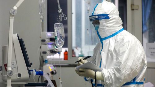 A medical worker records a patient's condition at Jinyintan Hospital designated for new coronavirus infected patients, in Wuhan in central China's Hubei province.