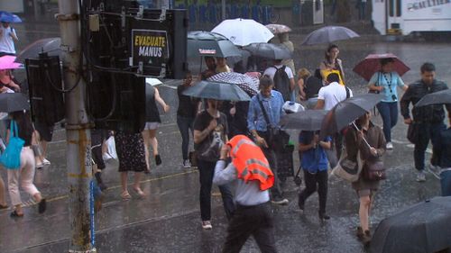 Tram lines were left submerged on Bourke Street and pedestrians battered as the storm returned with force this afternoon. (9NEWS)