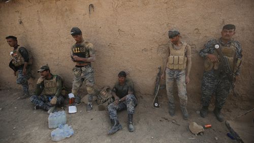 Iraqi government forces rest in the village of al-Khuwayn, south of Mosul, after recapturing it from Islamic State (IS) jihadists. Source: 
AHMAD AL-RUBAYE / AFP