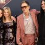 A-list couple joined by adult children on red carpet