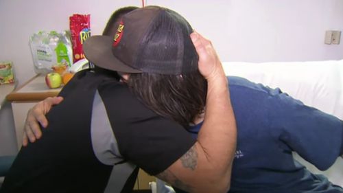 Liam and his dad, Adam, embrace. (9NEWS)