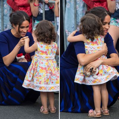 Meghan embraces a small child, 31 October 2018
