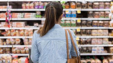 Woman does weekly grocery shop. 