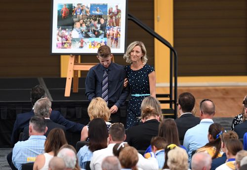 Reen Mercer and her son Brayden read a tribute during a memorial service for their husband and father Dean Mercer on the Gold Coast. (AAP)