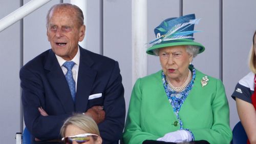 Prince Philip, Duke of Edinburgh and Queen Elizabeth II watch the England vs Wales women's hockey match at the Glasgow National Hockey Centre.