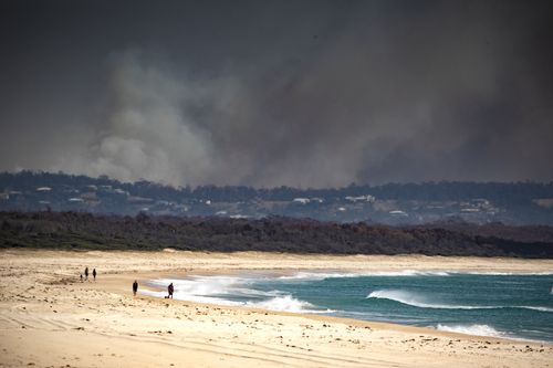 Smoke is seen in the distance near Tuncurry, NSW, November 9, 2019. (AAP Image/Shane Chalker) NO ARCHIVING