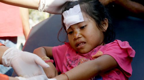 A girl injured in an earthquake is treated in Mataram, Lombok.