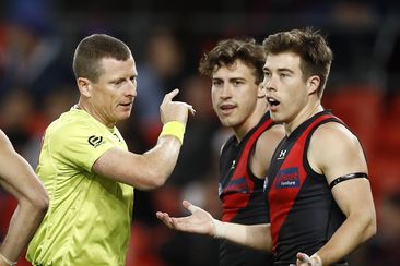 Zach Merrett of the Bombers questions the umpire.