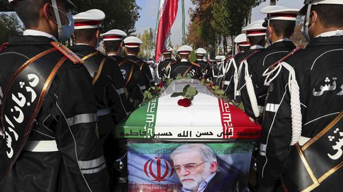Military personnel stand near the flag-draped coffin of Mohsen Fakhrizadeh during his funeral in Tehran, Iran, in November 2020.