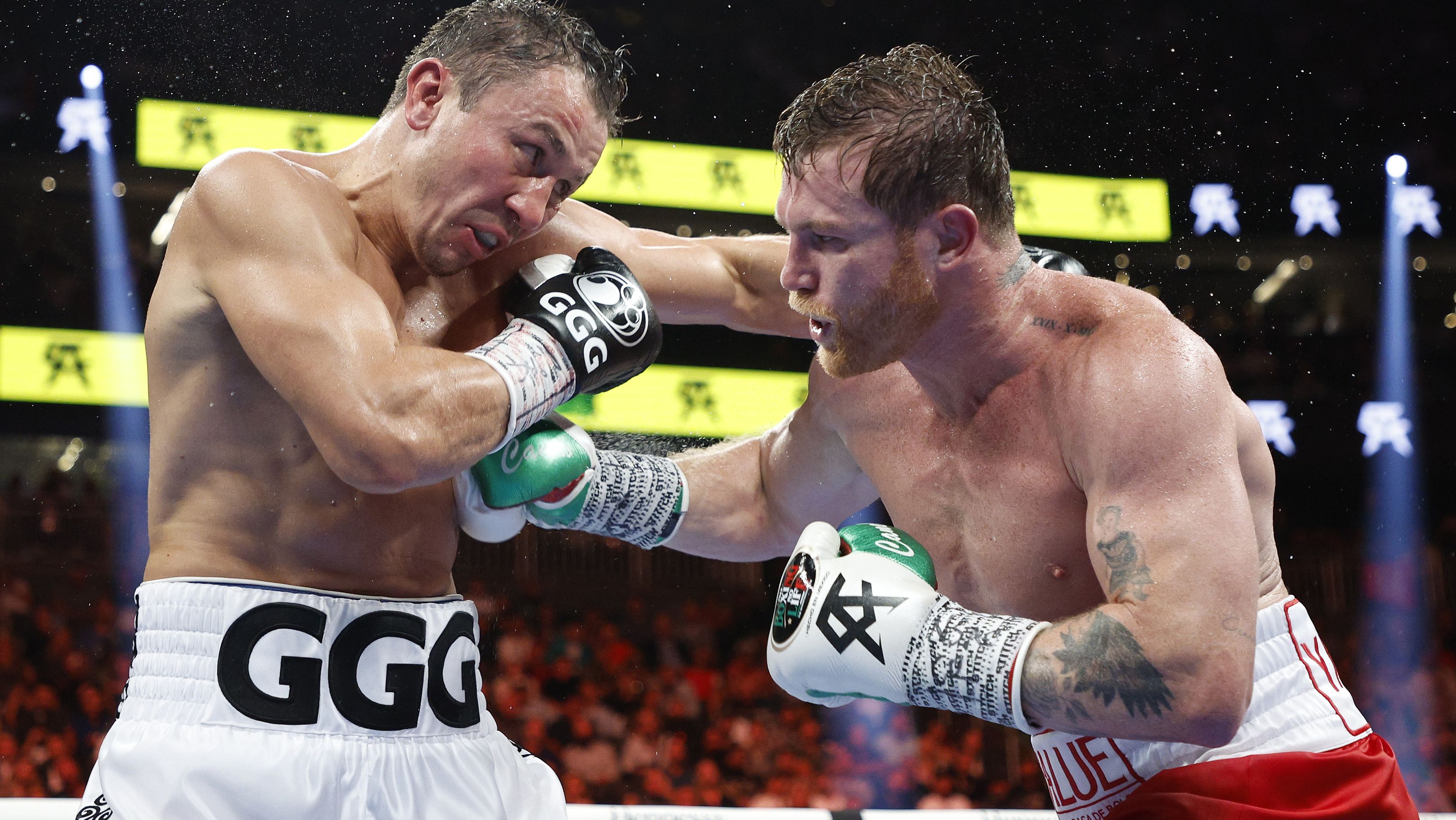 Canelo Alvarez (red trunks) and Gennadiy Golovkin (white trunks) exchange punches in the fight for the Super Middleweight Title at T-Mobile Arena.