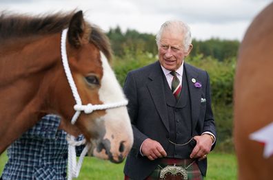 LANARK, SCOTLAND - SEPTEMBER 07: Prince Charles, Prince of Wales, known as the Duke of Rothesay while in Scotland, and Patron of the Clydesdale Horse Society, reacts after viewing a statue of a Clydesdale horse situated by Lanark Auction Market, Lanark Agricultural Centre on September 7, 2022 in Lanark, Scotland. The Duke and Duchess of Rothesay visit Lanarkshire and the Scottish borders. (Photo by Andrew Milligan - WPA Pool/Getty Images)