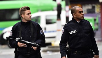 Police patrol near a crime scene at the Rue de Charonne in Paris on November 14, 2015, following a series of coordinated attacks in and around Paris which left more than 120 people dead.  (AFP)