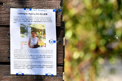A poster seeking information for missing woman Qi Yu seen on an overpass on the M1 Highway. Picture: AAP