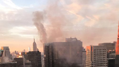 Smoke rises from Trump Tower in New York. (AAP)