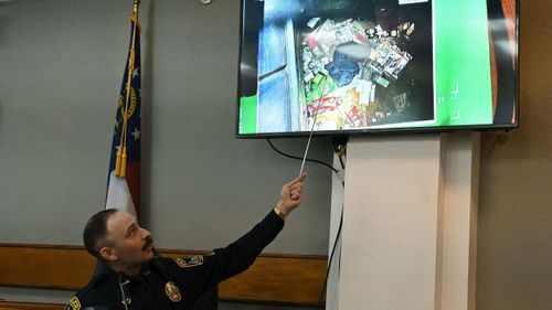 Athens-Clarke County police officer Zachary Davis points out the jacket he collected from a dumpster as he testifies during a trial of Jose Ibarra on November 15.Mandatory Credit:	Hyosub Shin/Pool/Atlanta Journal-Constitution/AP via CNN Newsource