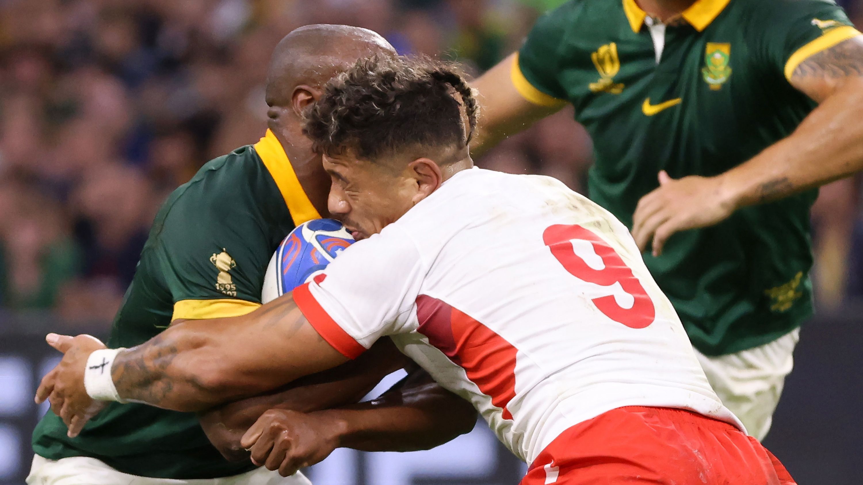 Augustine Pulu of Tonga clashes heads with Makazole Mapimpi of South Africa.
