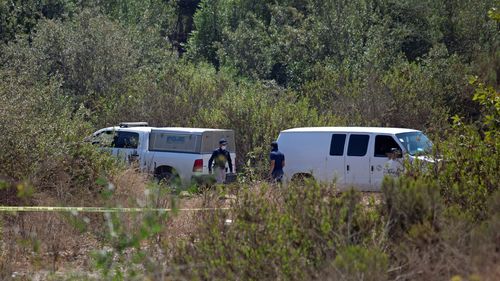 Forensic technicians work at the scene where two young American children were found dead, in Rosarito, Baja California state, Mexico August 9, 2021. Picture taken August 9, 2021. REUTERS/Stringer NO RESALES. NO ARCHIVES
