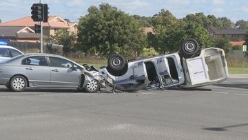 A police paddy wagon has rolled into its roof after colliding with a Honda Accord in Sydney&#x27;s south west.