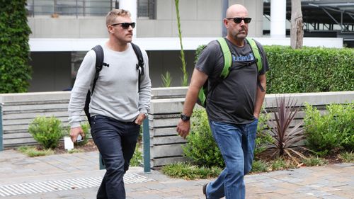 Cricketer Aaron Finch and Australian coach Darren Lehmann leave St Vincent's Hospital after visiting Phillip Hughes. (AAP)