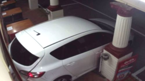 A stolen white Mazda slams into the pub, and was later found burned out by police.