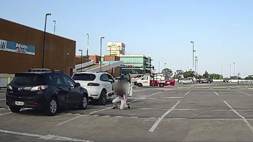 Sandra can be seen rolling out of her car onto the concrete and escaping before the alleged carjacker speeds off.