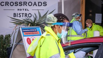 Medical staff at a pop-up COVID-19 testing clinic, perform tests on drivers in the Sydney suburb of Casula.