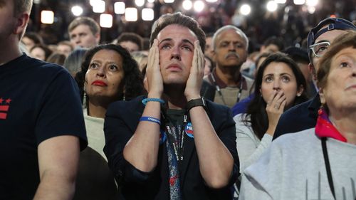 Forlorn Clinton fans watch the results come in at her election night event on November 9, 2016. (AAP)