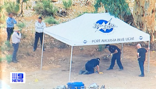 Forensic police examine the site of a suspected shallow grave in the Flinders Rangers.