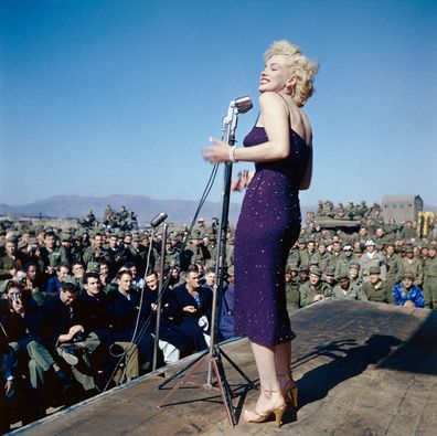 1954...Marilyn Monroe entertaining U.S. troops in South Korea. She is showing her left profile in this full length photograph.