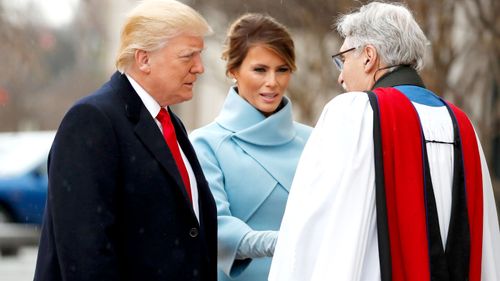 Reverend Luis Leon greets President-elect Donald Trump and his wife Melania as they arrive for a church service at St. John's Episcopal Church across from the White House. (AAP)