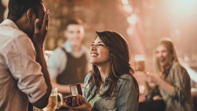 Woman proposes to man. Couple get engaged. Proposal. Couple's engagement. 