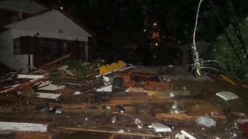 Debris lays in piles after a tsunami hit Los Vilos. (Citizen Corporation National Emergency Network)