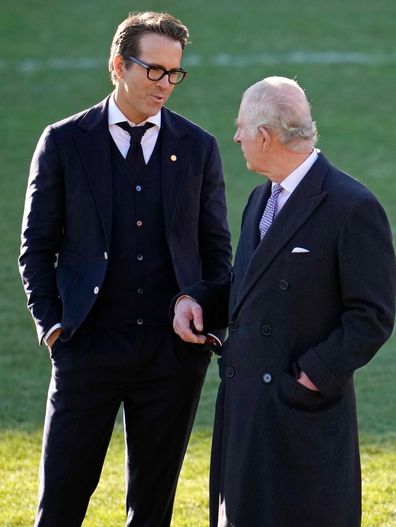 King Charles III talks to Co-Owner Wrexham AFC Ryan Reynolds (L) during their visit to Wrexham AFC on December 09, 2022 in Wrexham, Wales. 