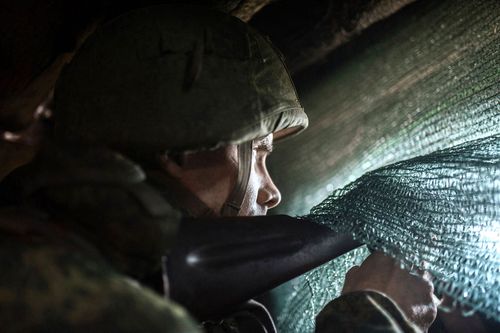 A pro-Russian serviceman sits in the advanced trenches of the people's militia of the Donetsk People's Republic in the Yasne village area, Donbas